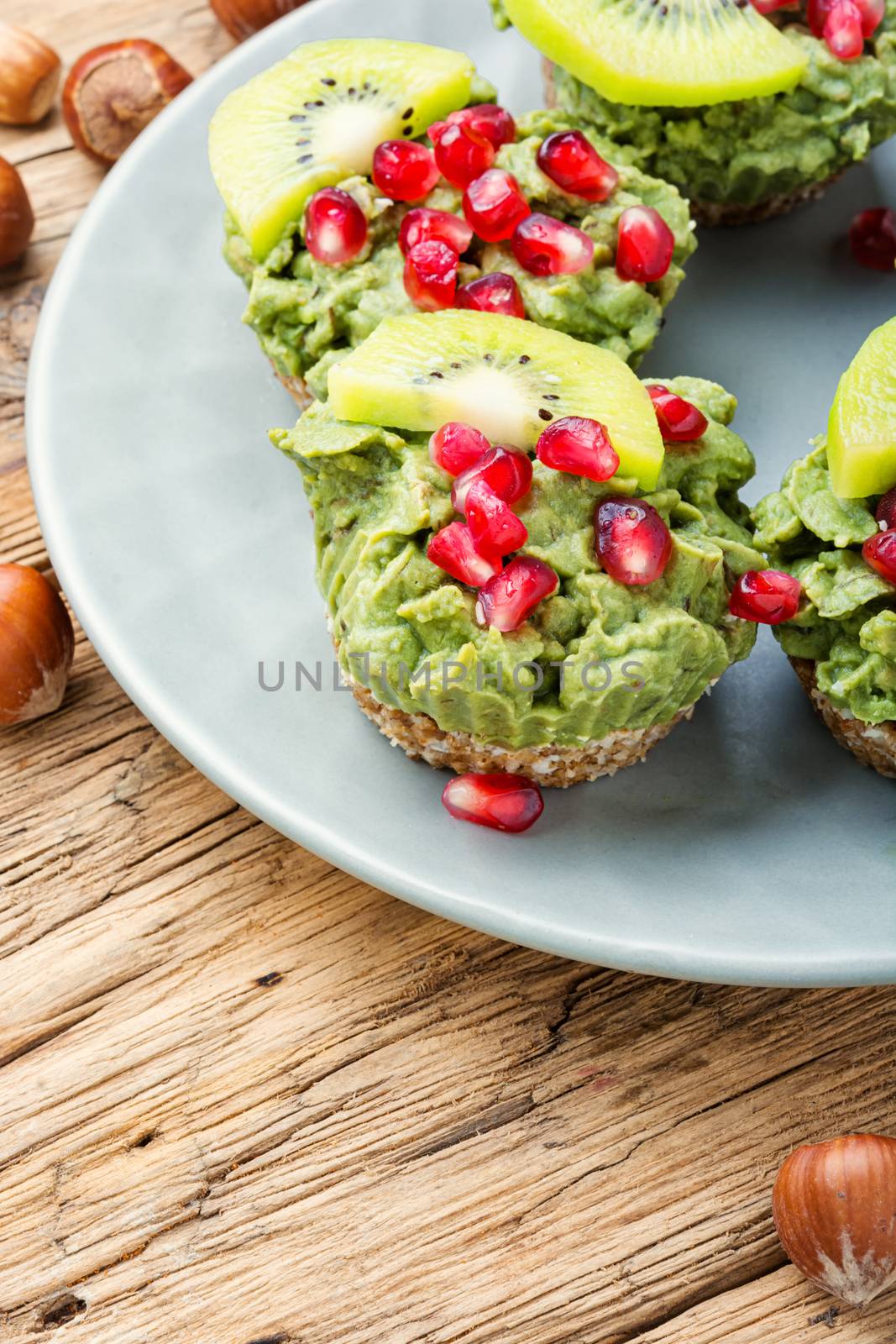 Avocado cupcakes or muffin garnished with kiwi and pomegranate.Cupcakes, close-up.