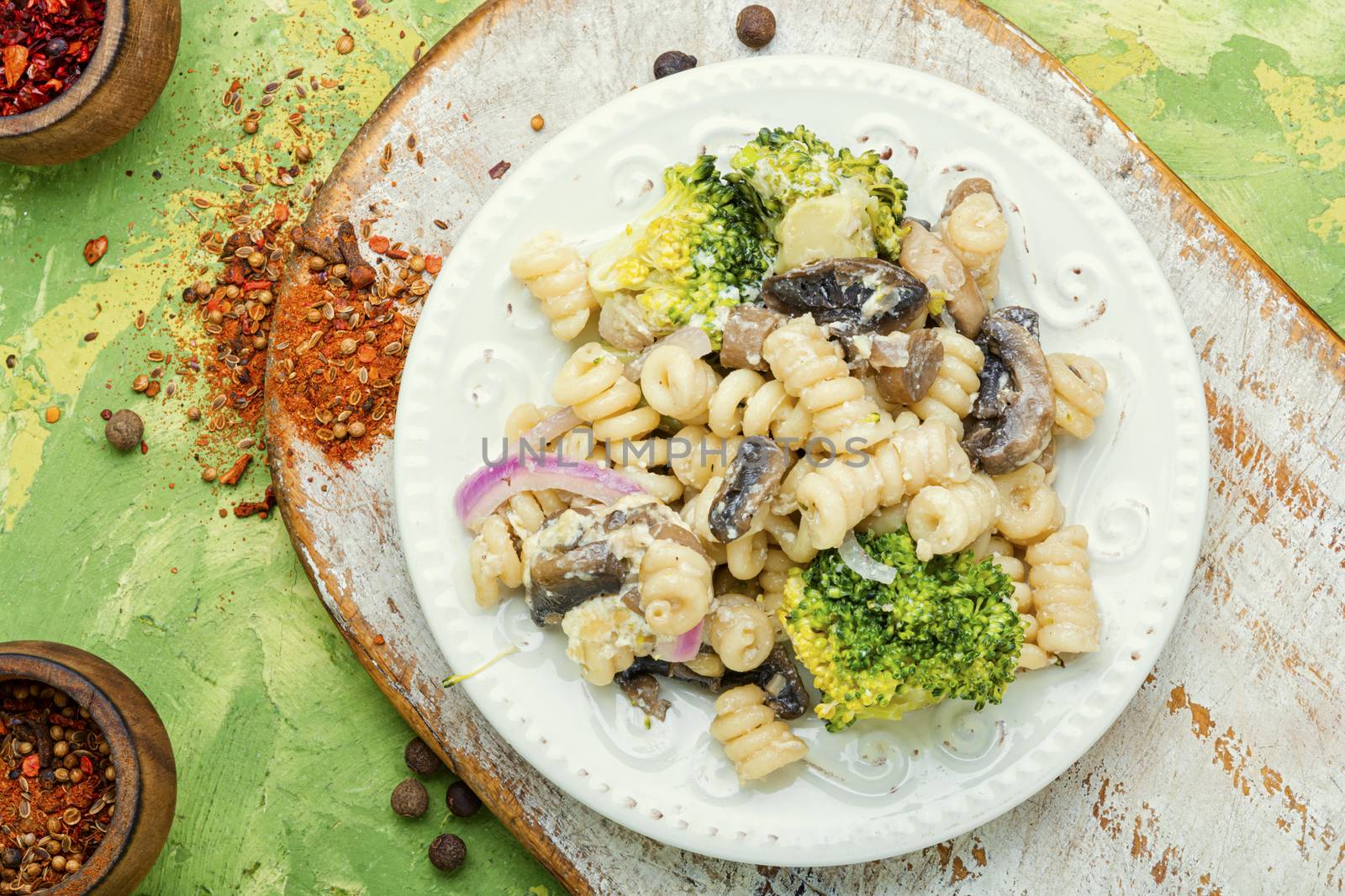 Italian pasta farfalle with broccoli and mushrooms.Italian food