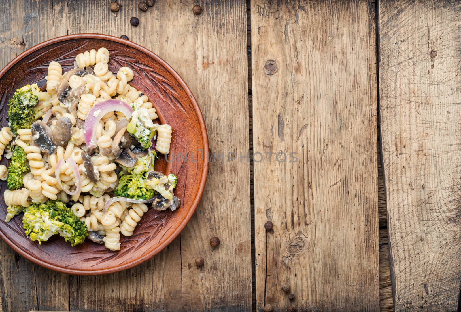 Italian pasta farfalle with broccoli and mushrooms.Italian food