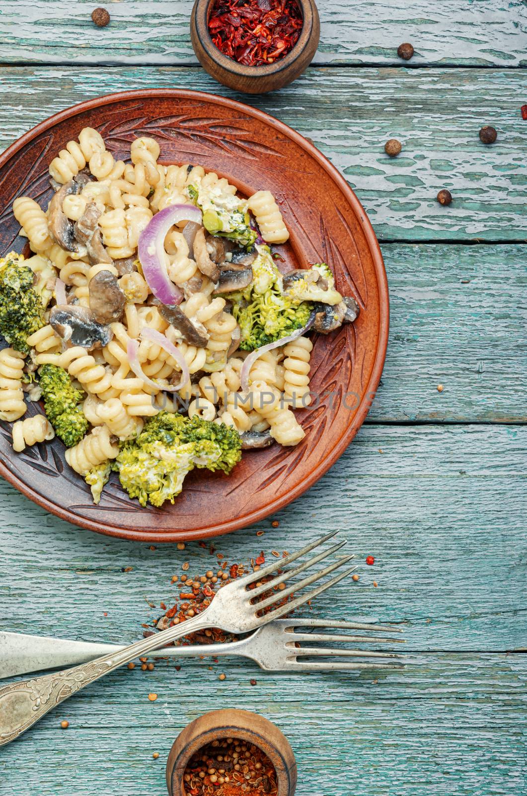Plate of iItalian pasta with broccoli.Italian food.Vegetarian vegetable pasta wooden table.