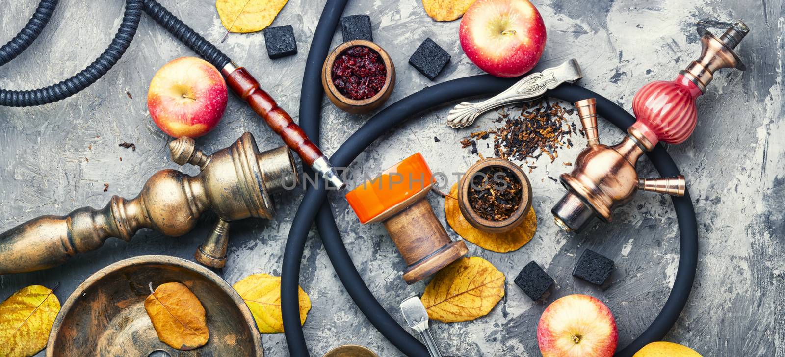 Preparation of a smoking hookah.Oriental hookah with a fruit aroma.Hookah on an apple.