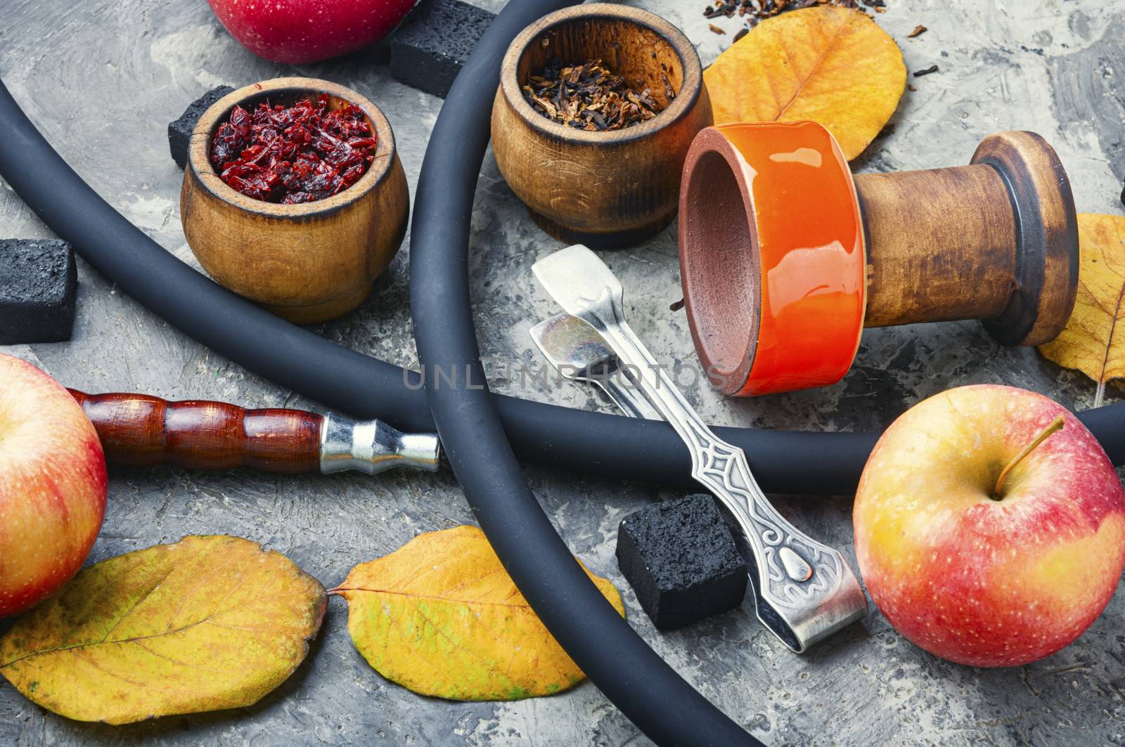 Preparation of a smoking hookah.Oriental hookah with a fruit aroma.Hookah on an apple.