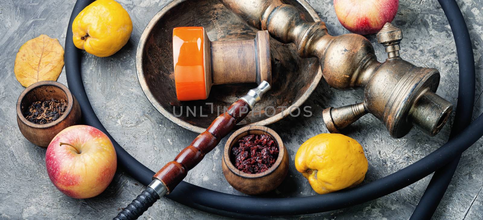 Preparation of a smoking shisha.Oriental hookah with a fruit aroma.Hookah on an quince