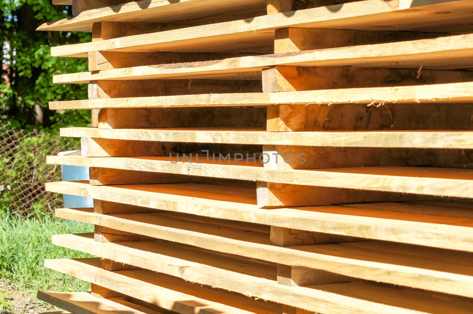 Wooden pallets stacked in the open air. For your design