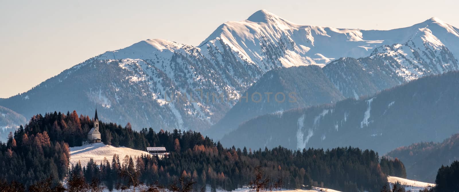 Mountain landscape, picturesque mountain church in the winter morning, large panorama by LucaLorenzelli