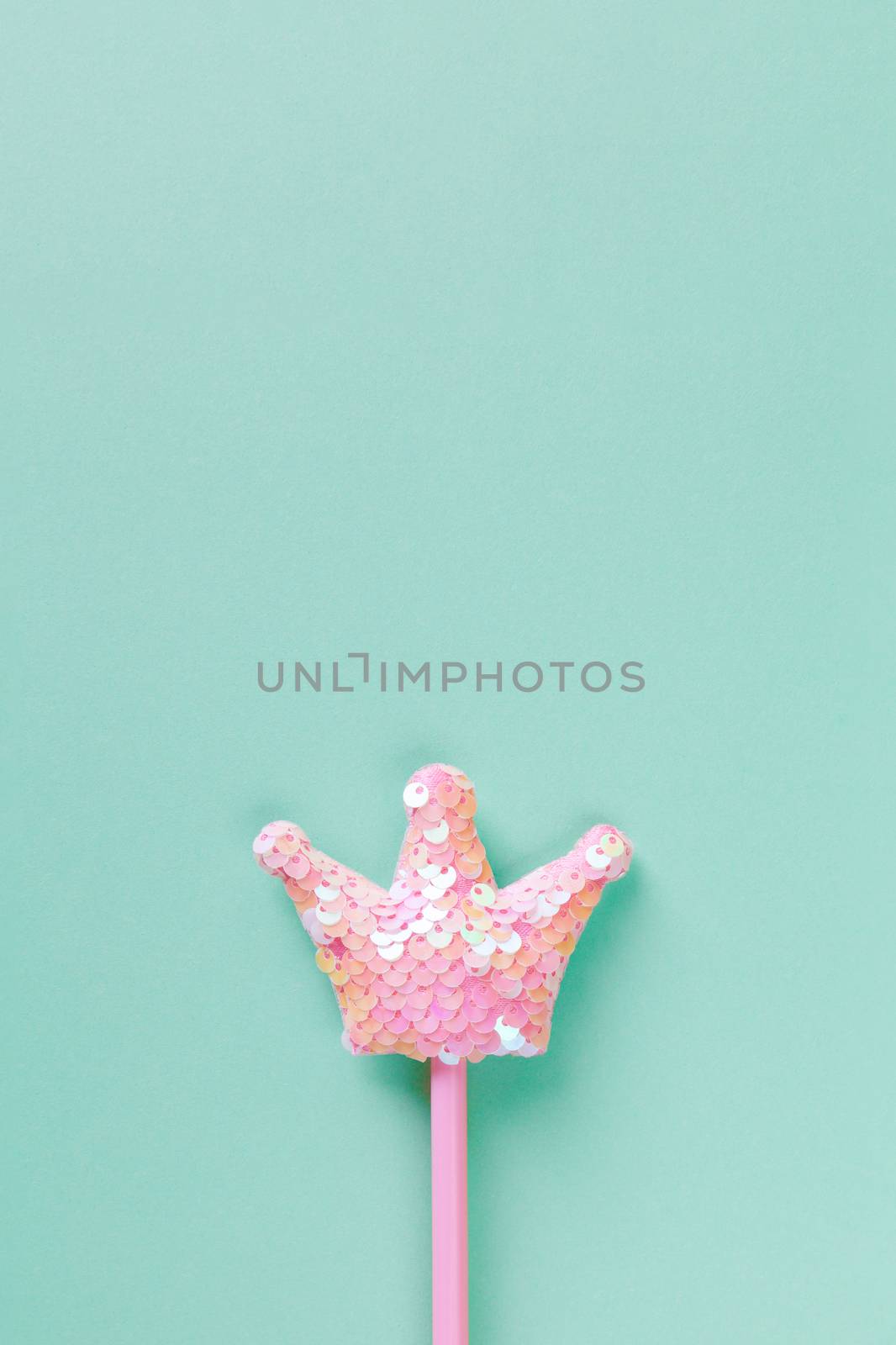 Party, carnival accessory, fairy wand on pastel turquoise background, copy space, flat lay. Minimal style. Vertical. Top view, close-up. For social media, decoration of stationery, posters.