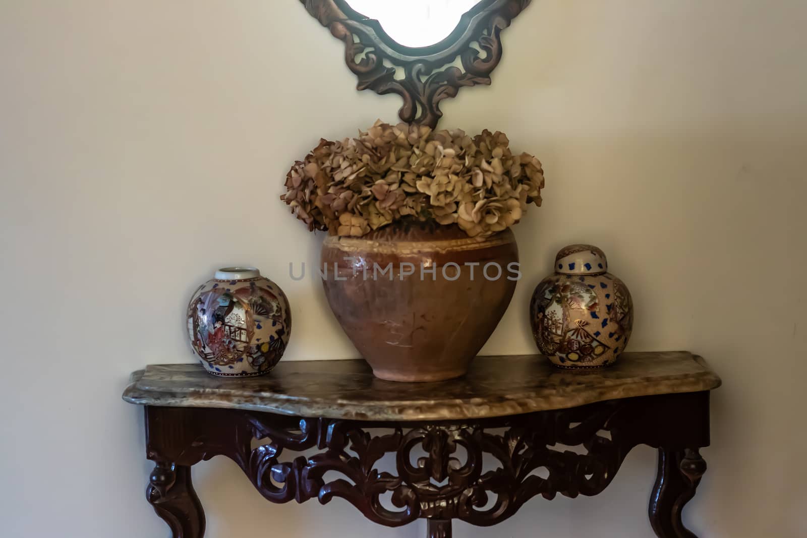 yellow color dominated good composed shoot from some antique items. there is some vases, containers and table.