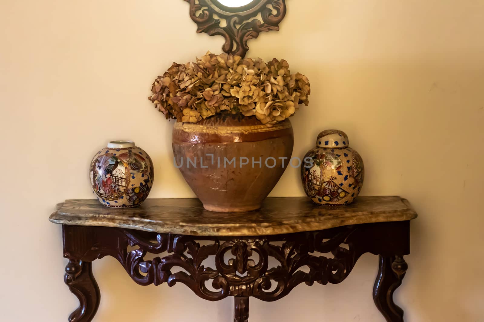 yellow color dominated good composed shoot from some antique items. there is some vases, containers and table.