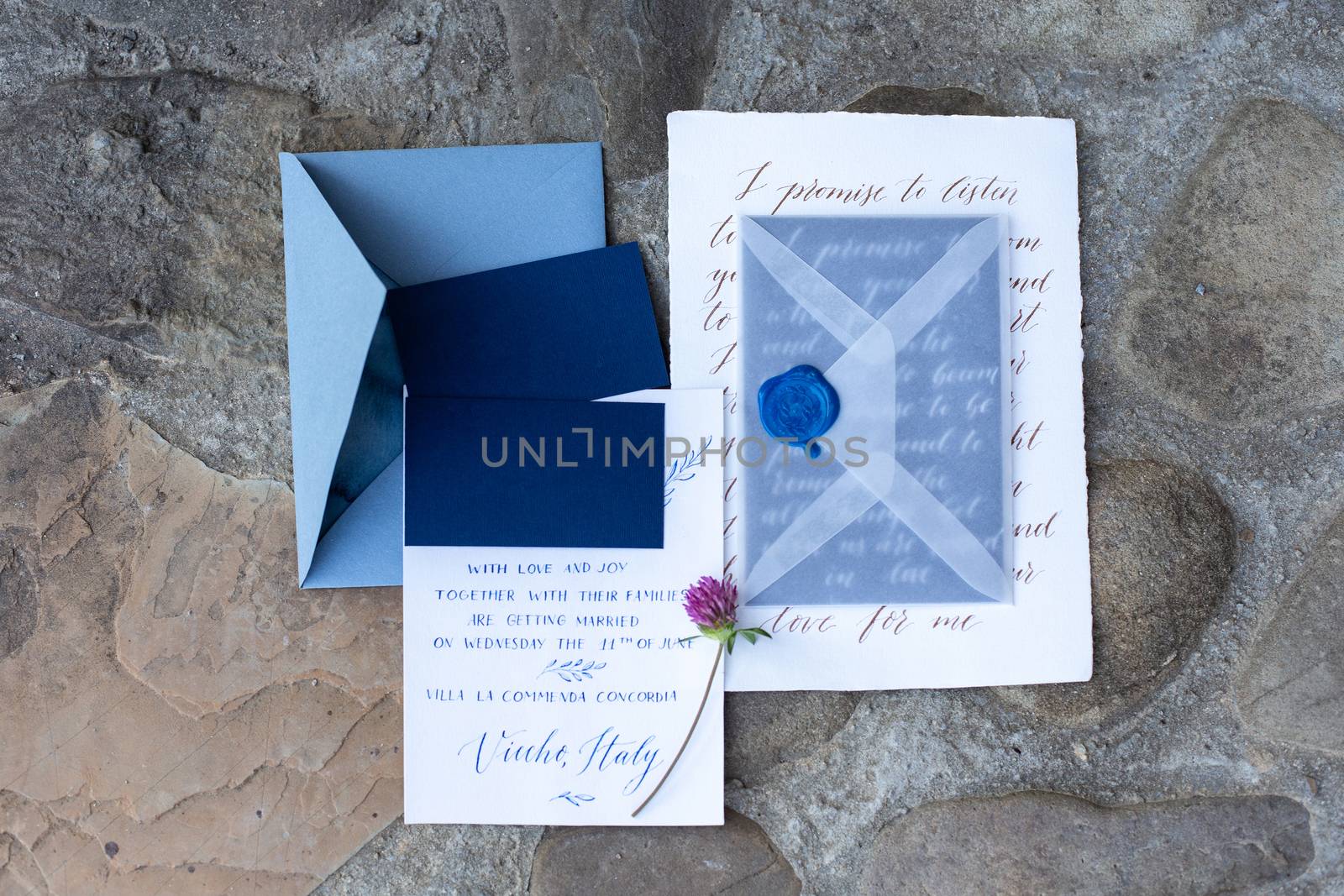 Wedding details flat lay on stone background. Wedding invitation. Ring box. Copyspace. Mock up.