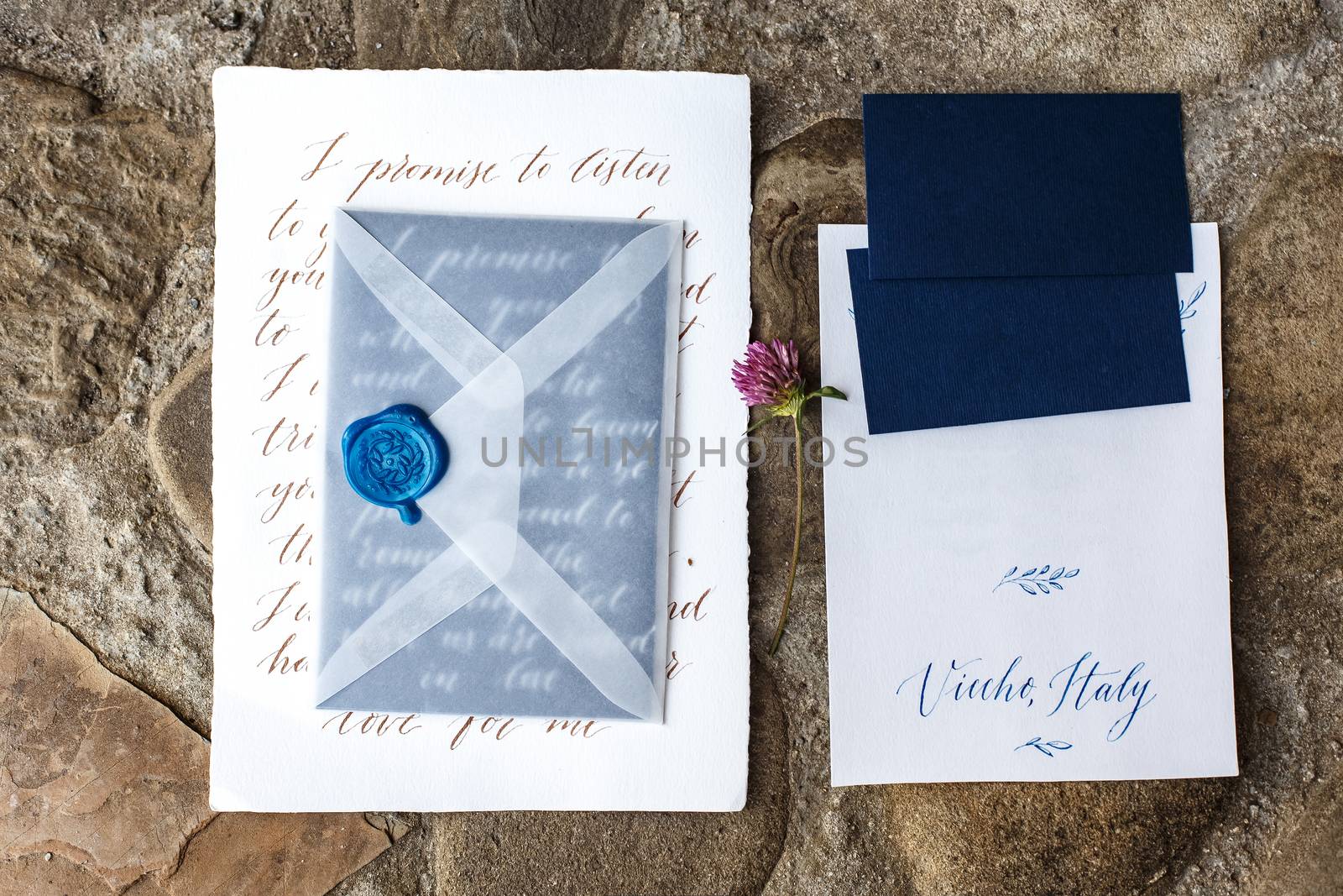 Wedding details flat lay on stone background. Wedding invitation. Ring box. Copyspace. Mock up.