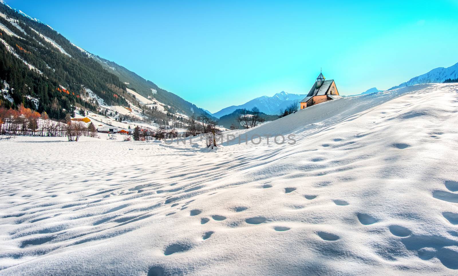 Mountain landscape, picturesque snow footprints in the winter morning panoramic church .