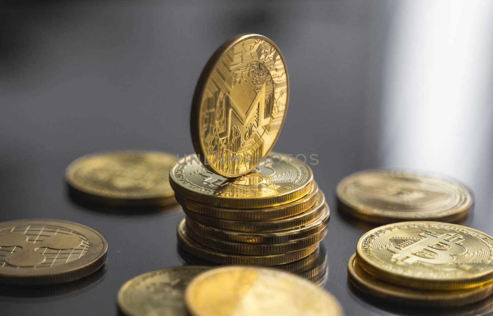 Stack of golden Monero bitcoin coin with a lot of bitcoins coins on a table. Virtual cryptocurrency concept. Mining of bitcoins online bussiness. Bitcoins trading. by vovsht