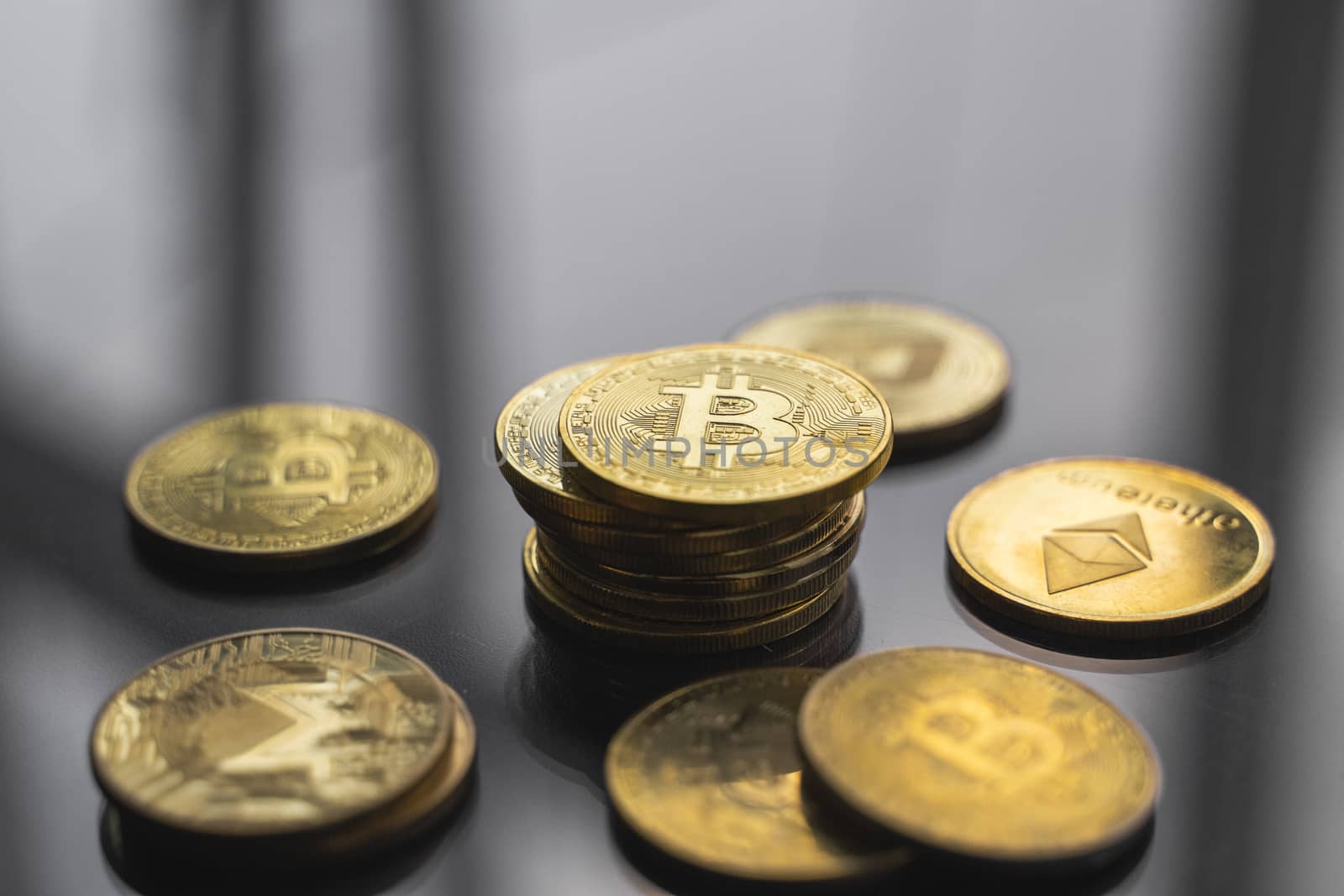 Stacks of golden bitcoin coins on a reflected surface of the table. Virtual cryptocurrency concept. Mining of bitcoins online business. Bitcoins trading
