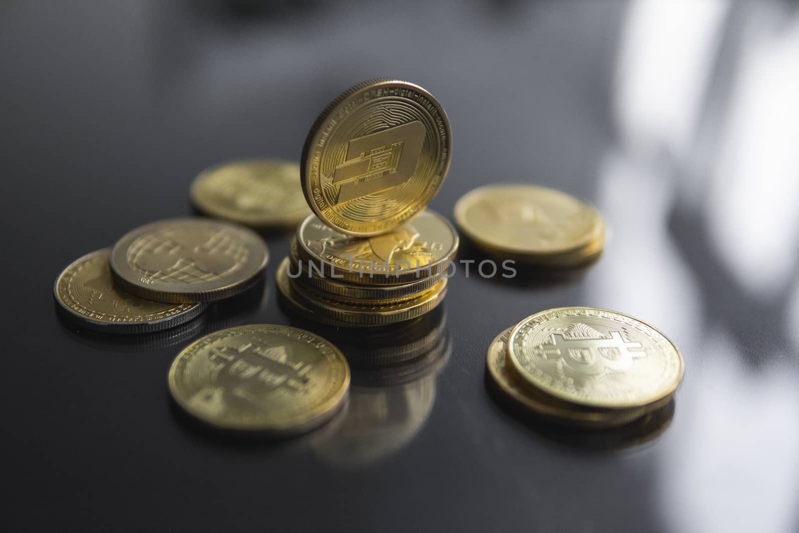 Stack of golden Dash bitcoin coin with a lot of bitcoins coins on a table. Virtual cryptocurrency concept. Mining of bitcoins online bussiness. Bitcoins trading