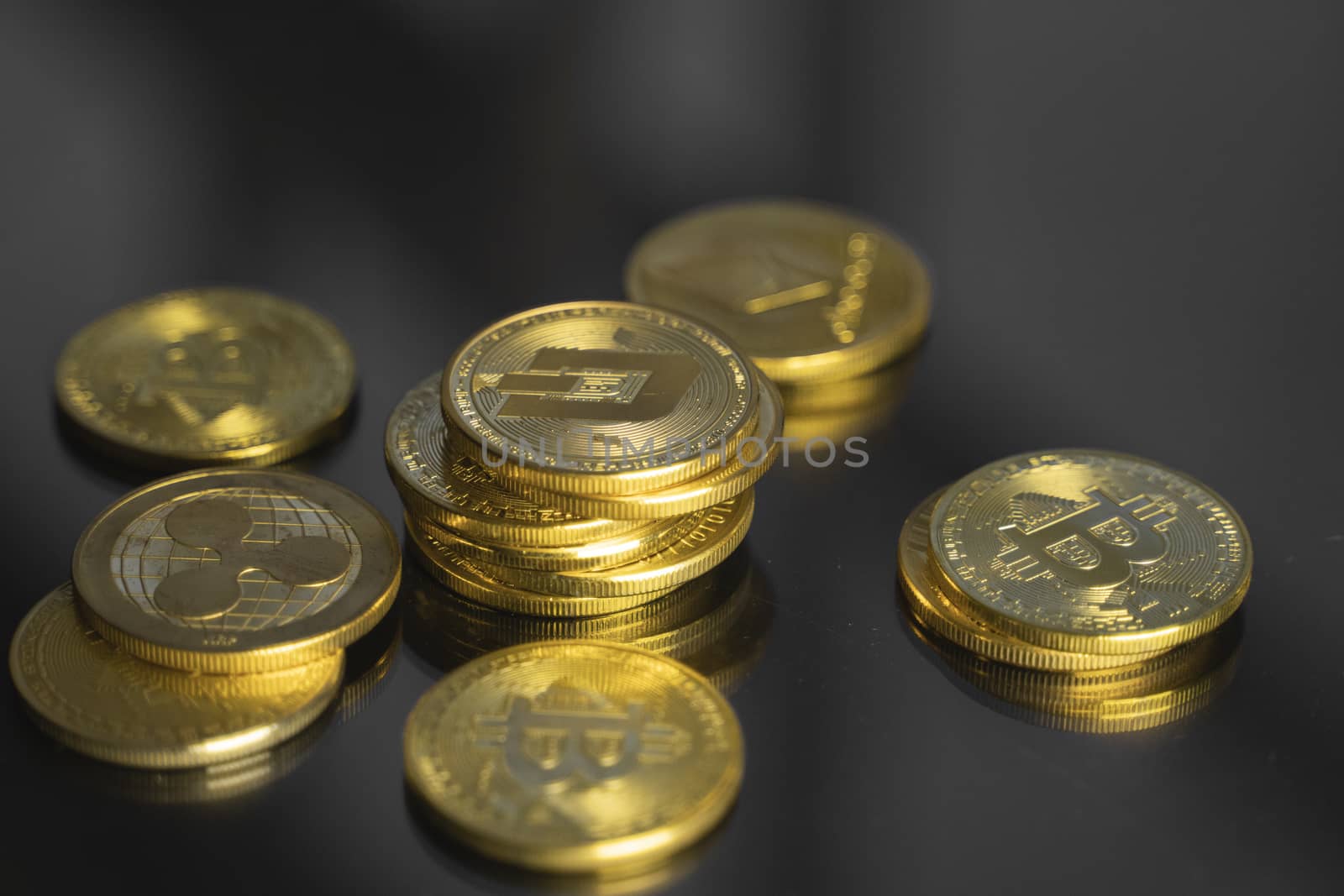 Stack of golden Dash bitcoin coin with a lot of bitcoins coins on a table. Virtual cryptocurrency concept. Mining of bitcoins online bussiness. Bitcoins trading. by vovsht