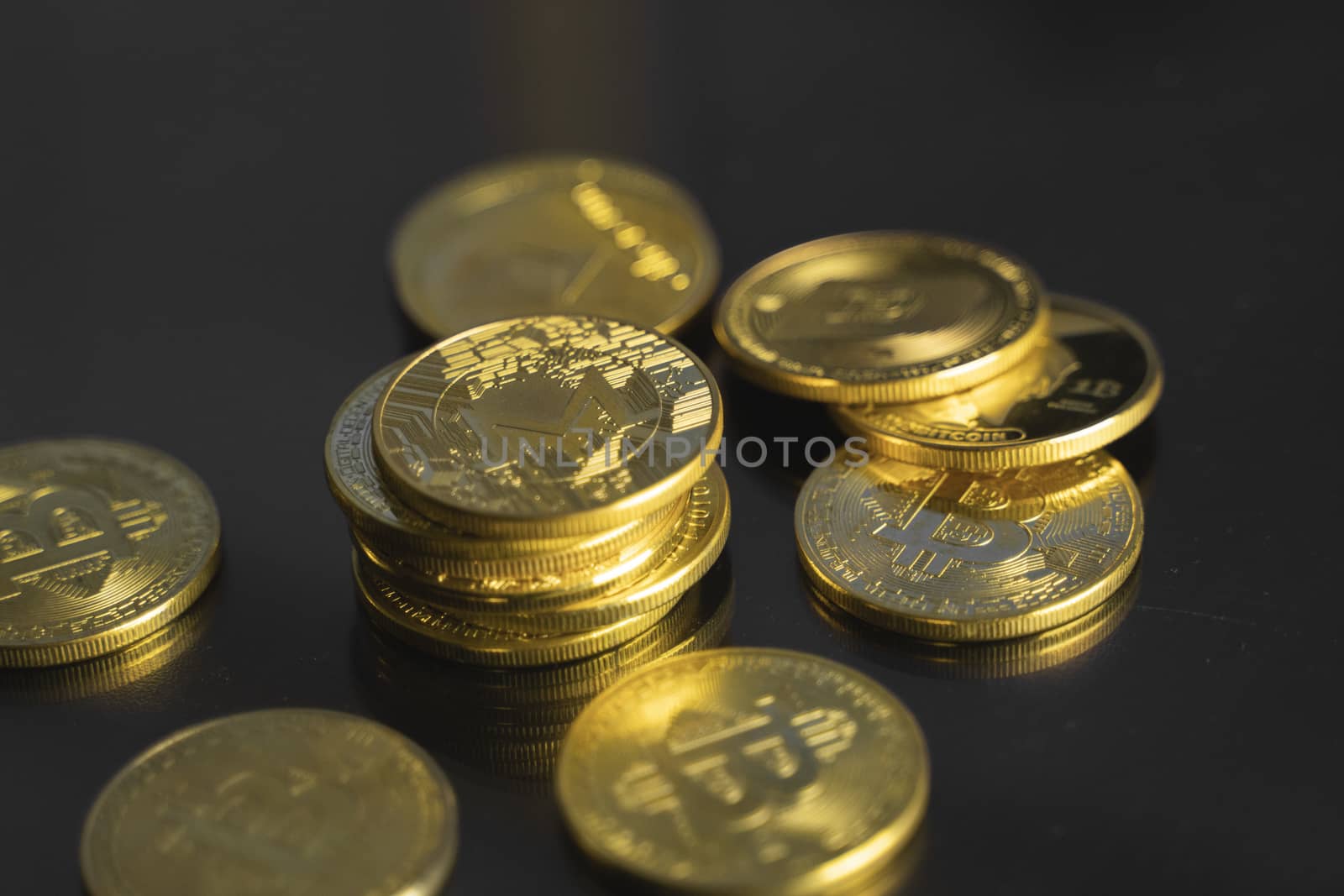 Stack of golden Monero bitcoin coin with a lot of bitcoins coins on a table. Virtual cryptocurrency concept. Mining of bitcoins online bussiness. Bitcoins trading