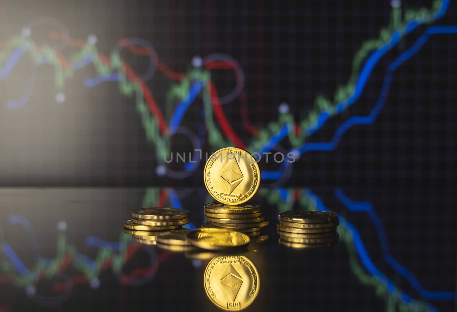 Ethereum and virtual money concept. Gold ethereum on a stack of coins with chart of growing and falling valuance of a cryptocurrency. Mining or blockchain technology