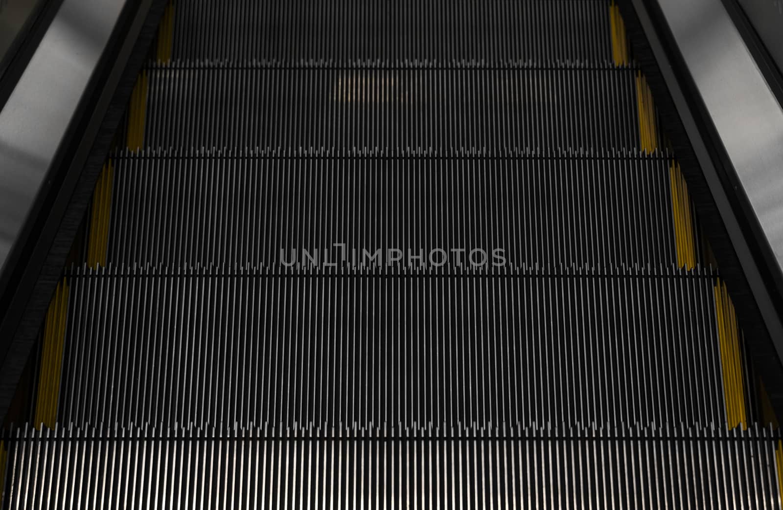 Modern escalator electronic system moving. Escalator is moving up.The ground is a straight line. Black with yellow band. by vovsht