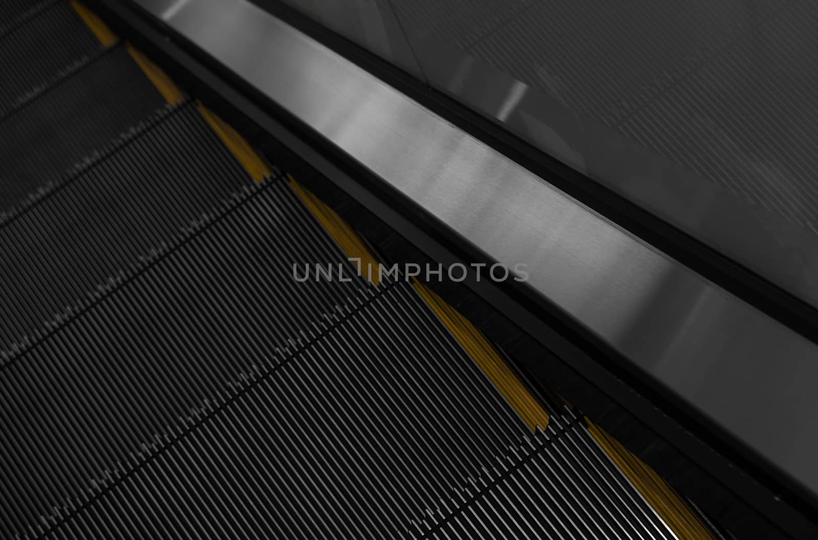 Modern escalator electronic system moving. Escalator is moving up.The ground is a straight line. Black with yellow band. by vovsht