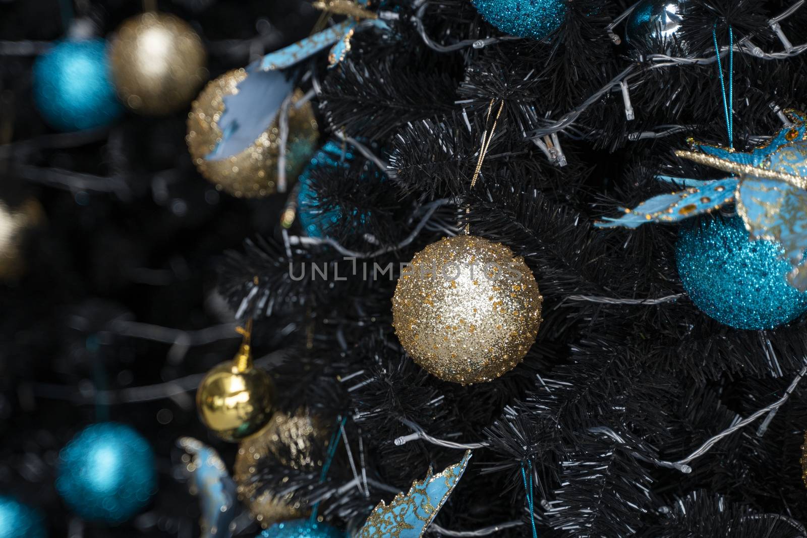 Decorated Christmas tree with a blue and gold toys and beautiful blue butterfly toy. Holidays. Preparation for New Year and Christmas