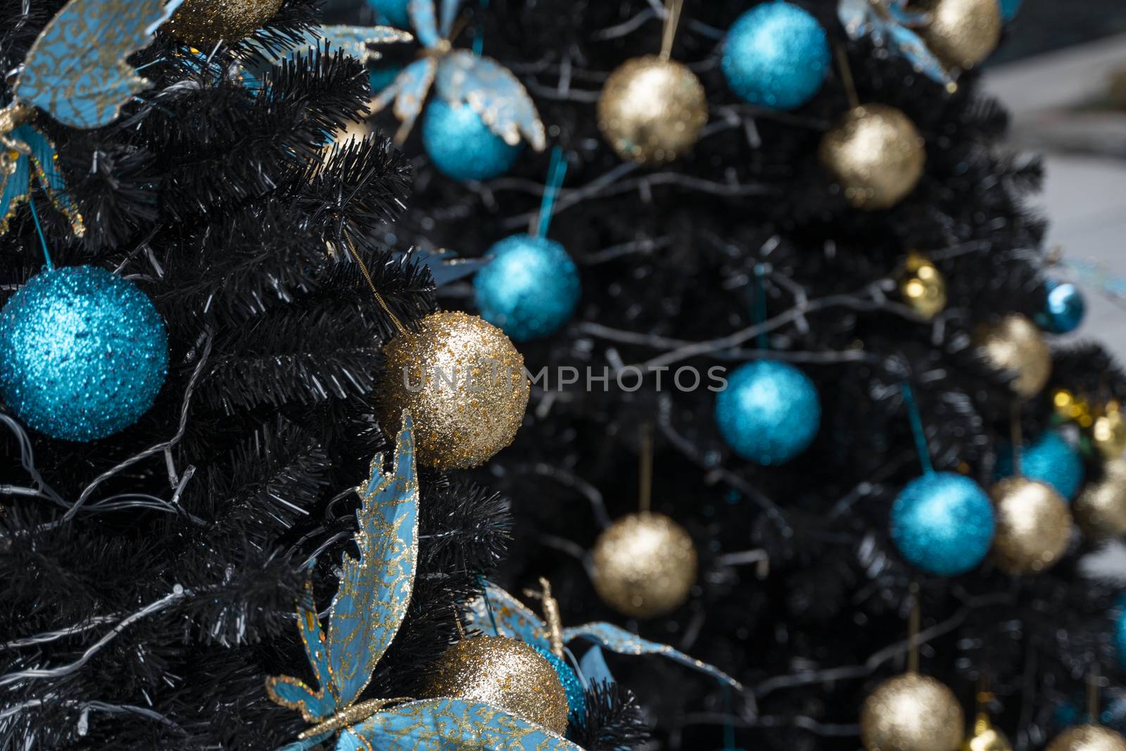 Decorated Christmas tree with a blue and gold toys and beautiful blue butterfly toy. Holidays. Preparation for New Year and Christmas