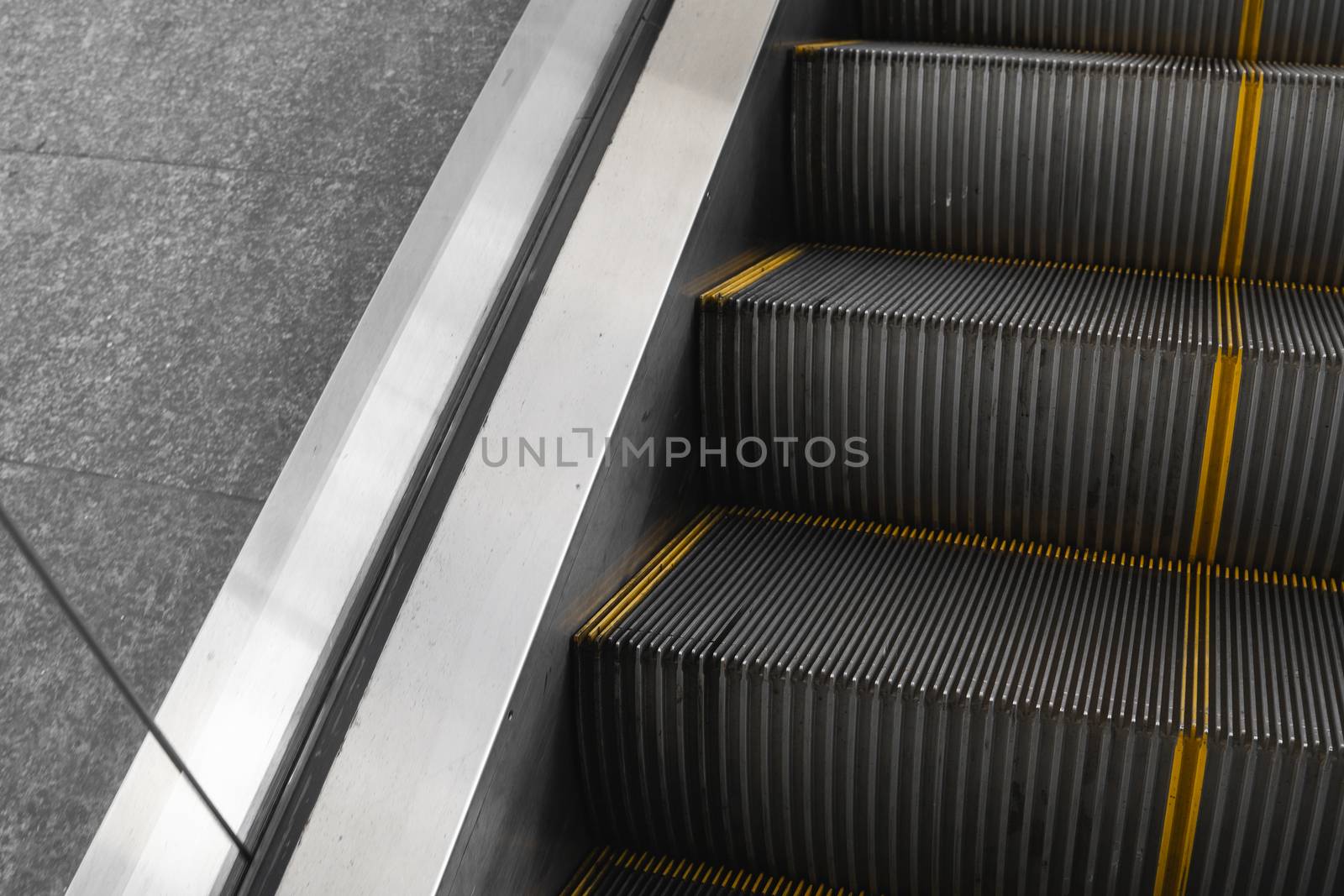 Ditry stairs on Escalator with yellow strips