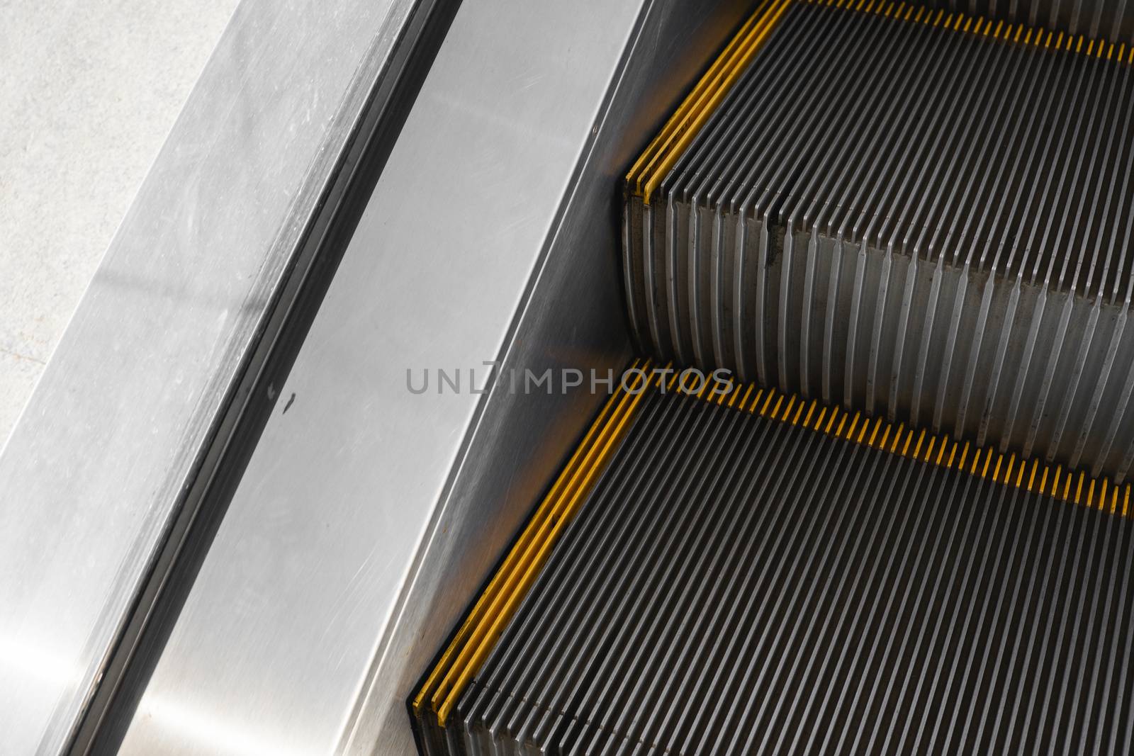 Ditry stairs on Escalator with yellow strips