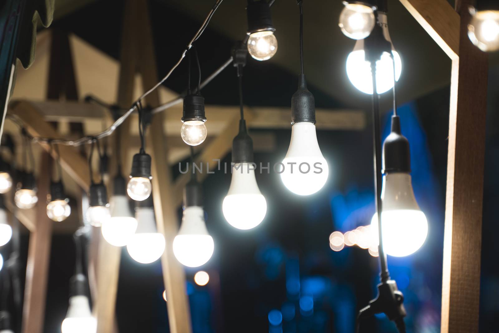 Decorative outdoor string lights in the evening. by vovsht