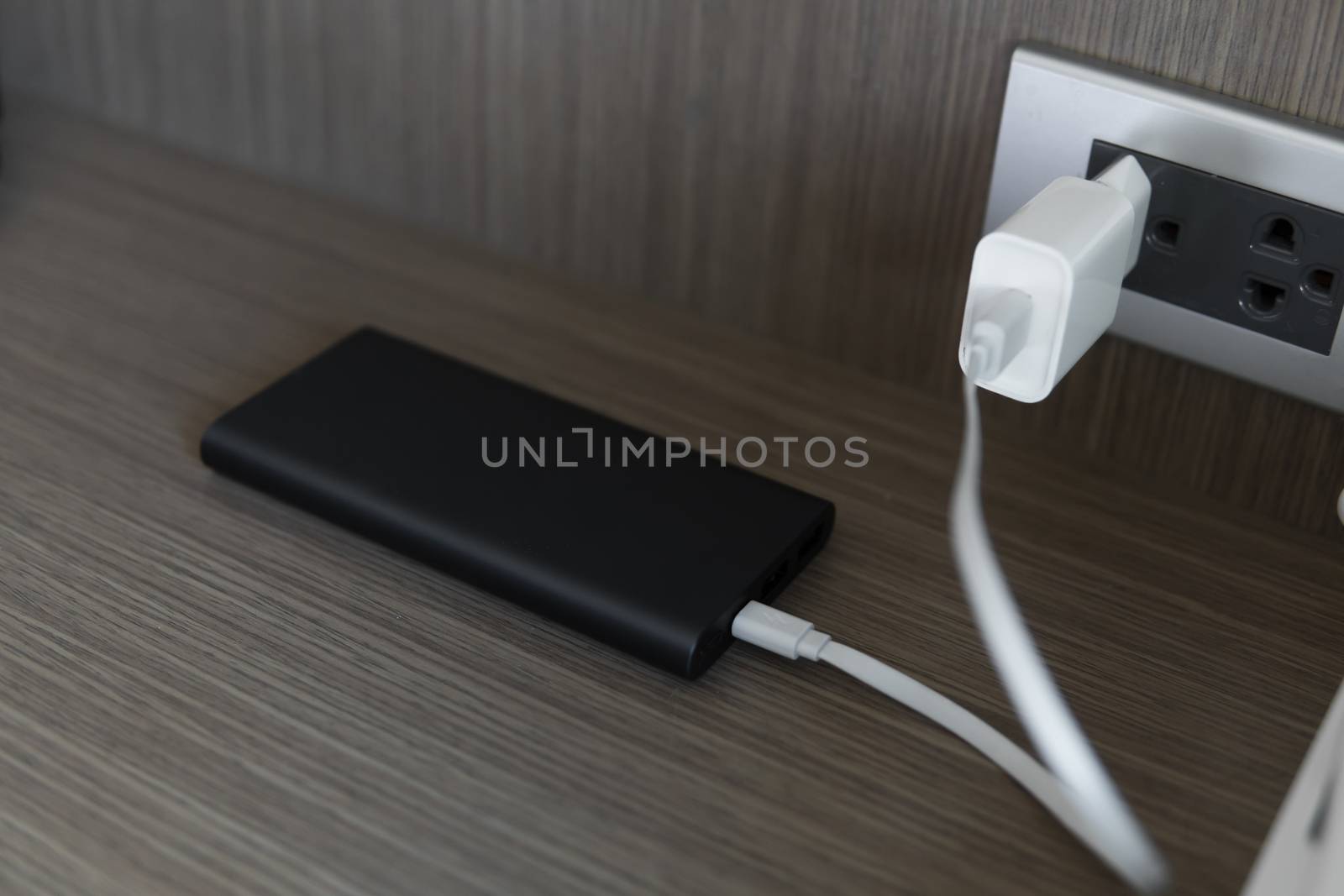 Charging of power bank. Power-saving device for smartphone and other devices. Helping to charge your phone. by vovsht