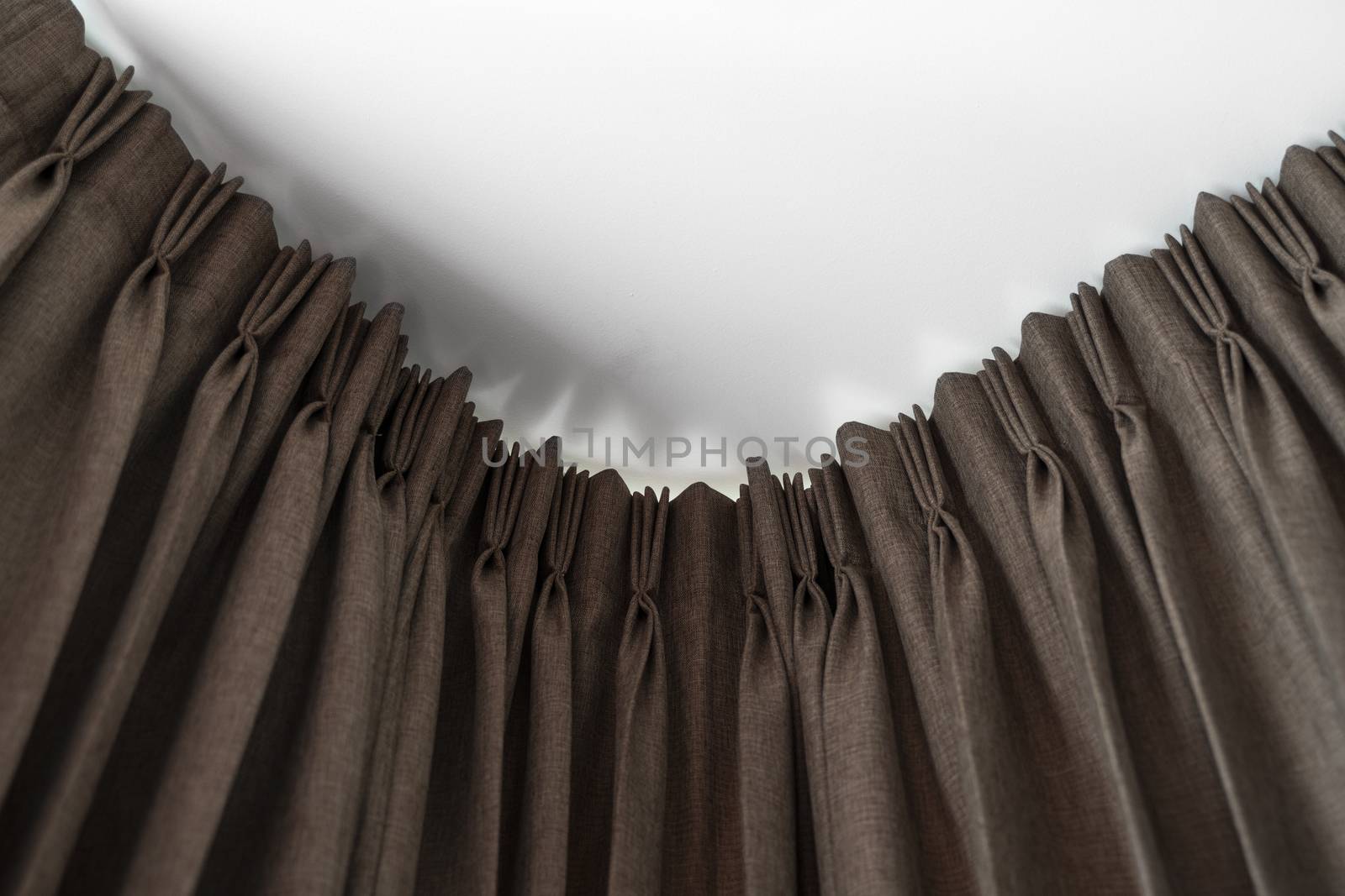 Brown curtains on a rail with a white ceiling. Curtain interior decoration in living or sleeping room. Comfortable live in your own home. Sweet confy home. by vovsht