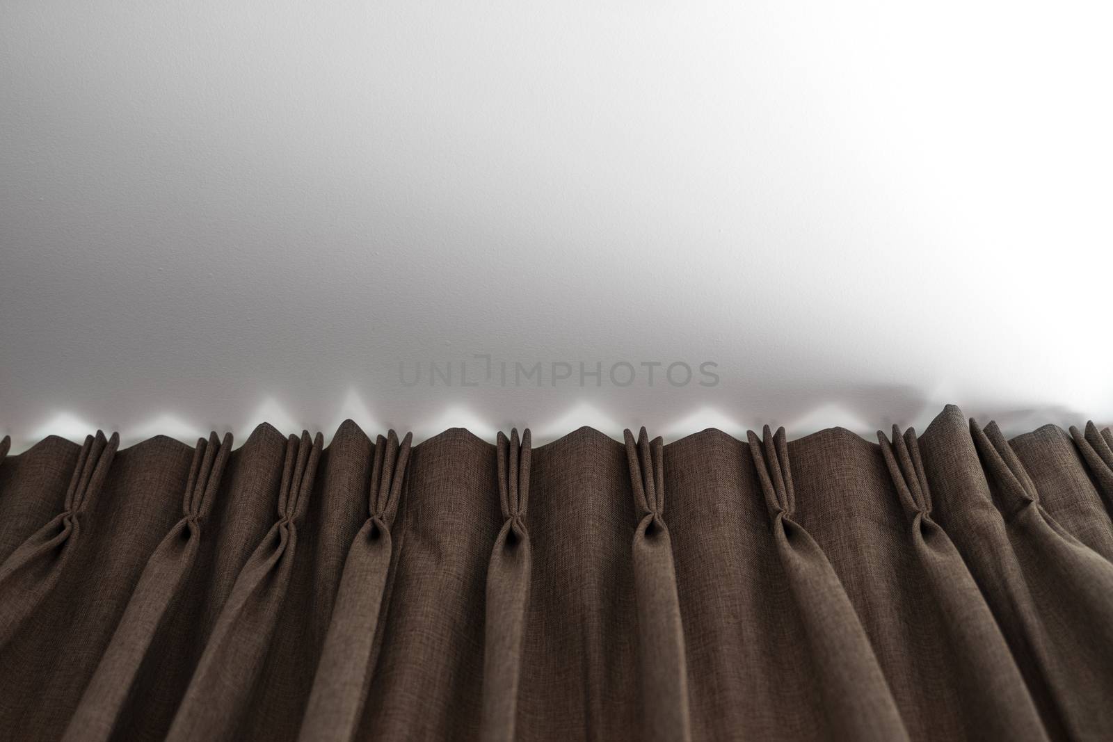 Brown curtains on a rail with a white ceiling. Curtain interior decoration in living or sleeping room. Comfortable live in your own home. Sweet confy home. by vovsht