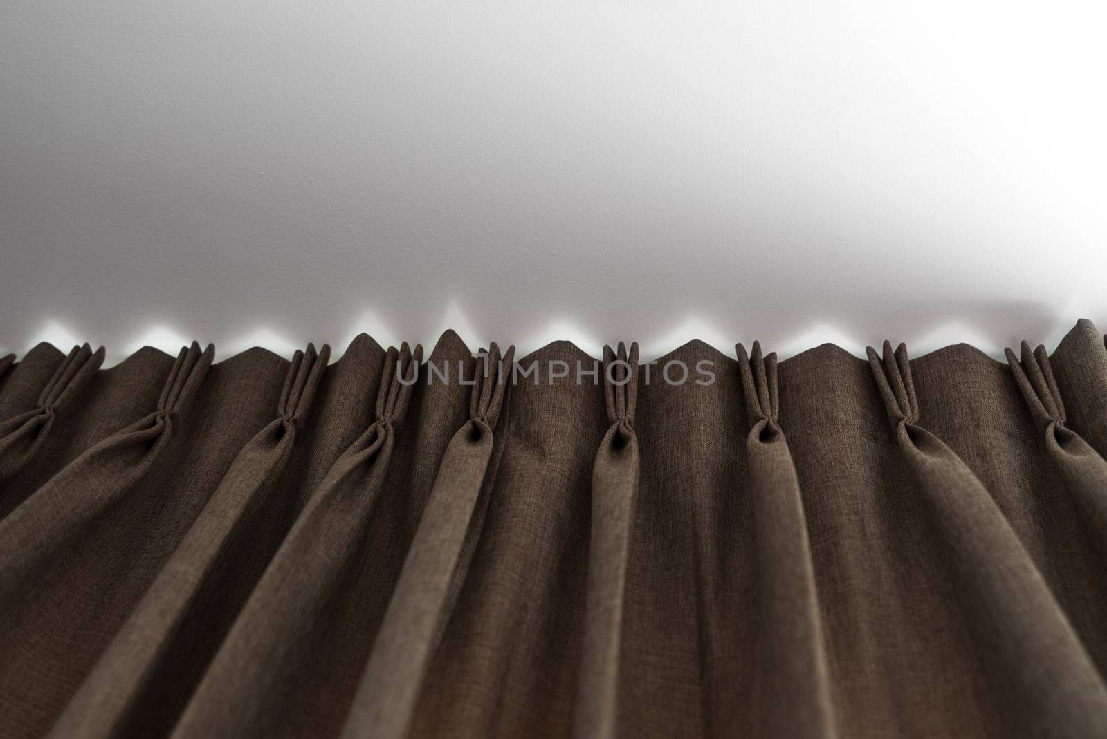 Brown curtains on a rail with a white ceiling. Curtain interior decoration in living or sleeping room. Comfortable live in your own home. Sweet confy home
