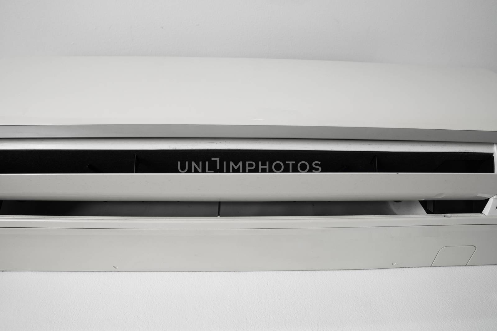 Air conditioner mounted on a white wall in the living room or bedroom. Indooor comfort temperature. Health concepts and energy savings