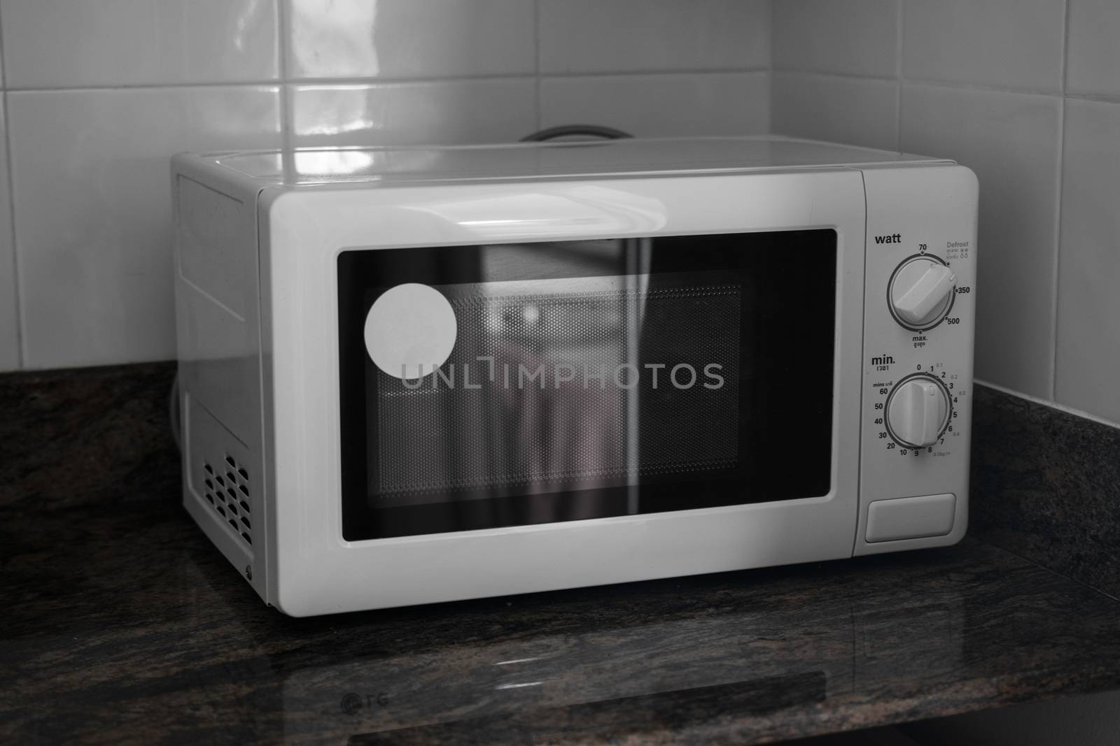 Microwave in a kitchen for cooking or heating a dish. by vovsht