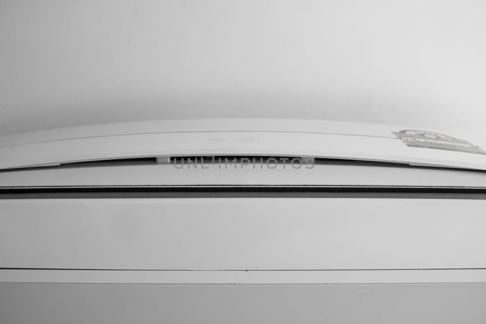 Air conditioner mounted on a white wall in the living room or bedroom. Indooor comfort temperature. Health concepts and energy savings. by vovsht