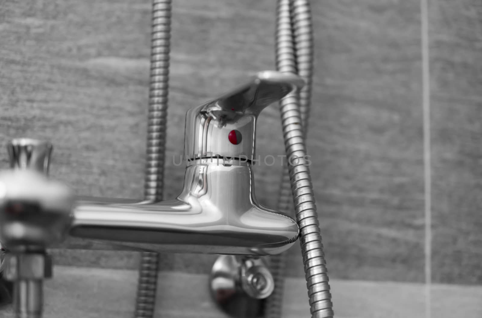 Modern designer tap and shower in bathroom. Closeup of chrome shower, faucet, in the bathroom covered decorative ceramic. Mixer cold hot water. by vovsht