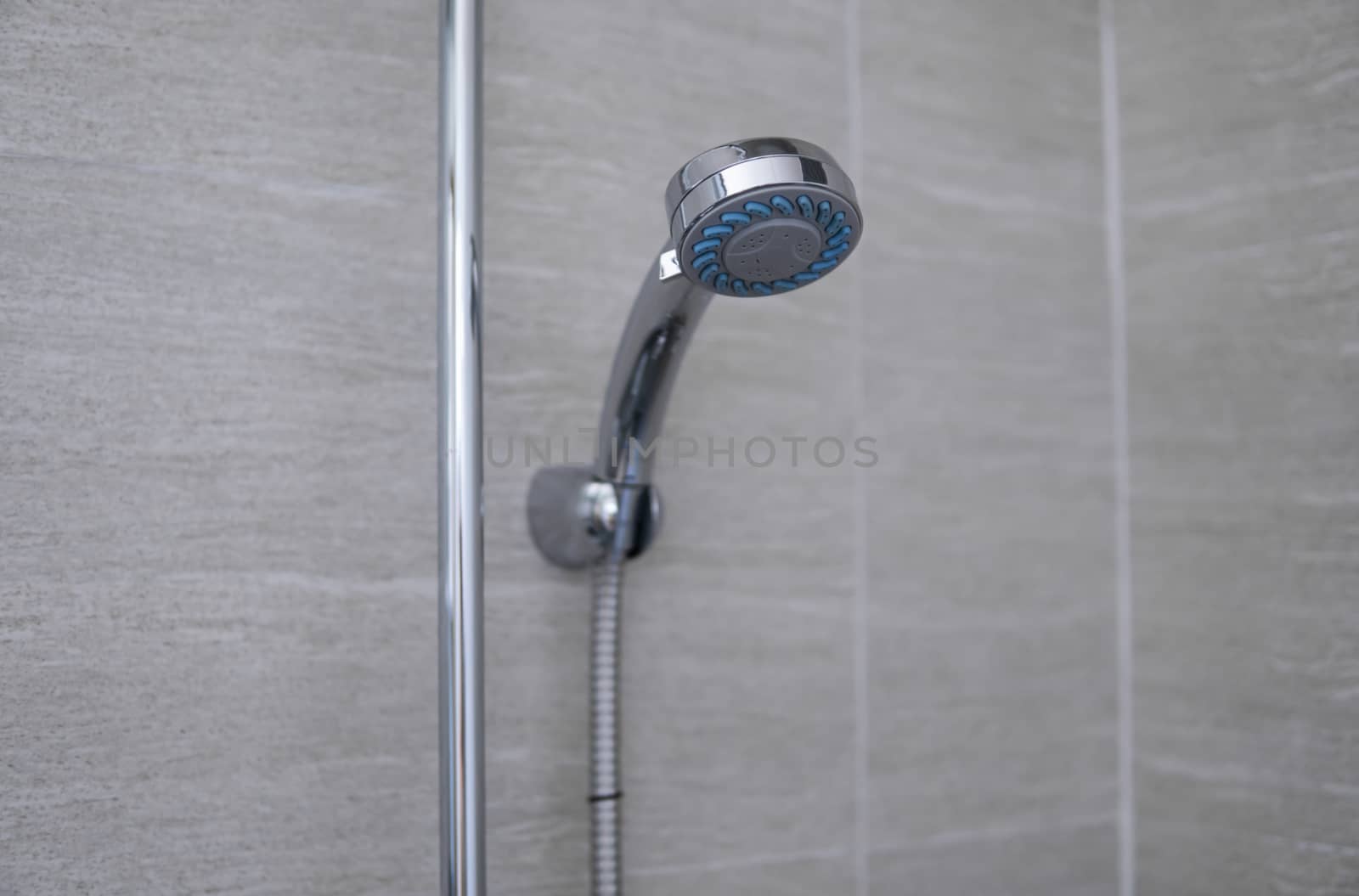 Modern shower head in modern bathroom. Shower head in bathroom with water spray or water flow. Feeling relax and enjoy in private bathroom. Fresh water flow from shower head for cleaning body dirty. by vovsht