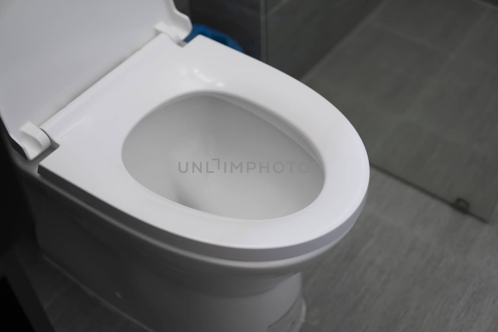 White toilet in modern home. White toilet bowl in bathroom. by vovsht