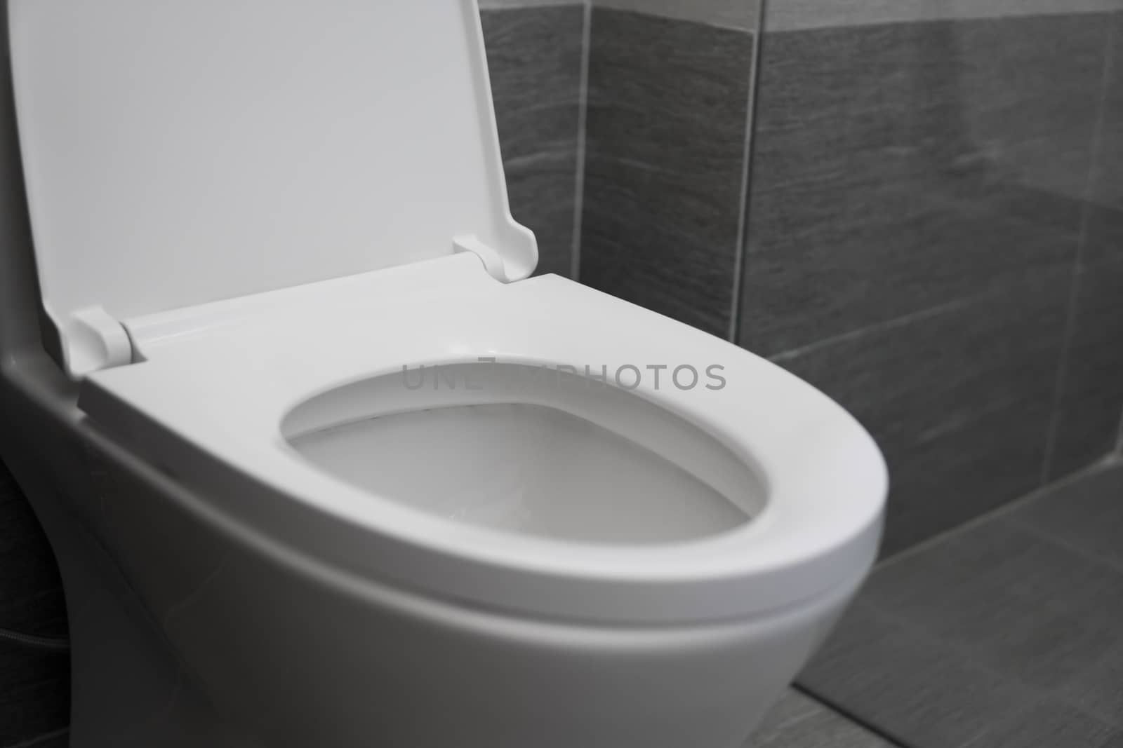 White toilet in modern home. White toilet bowl in bathroom. by vovsht