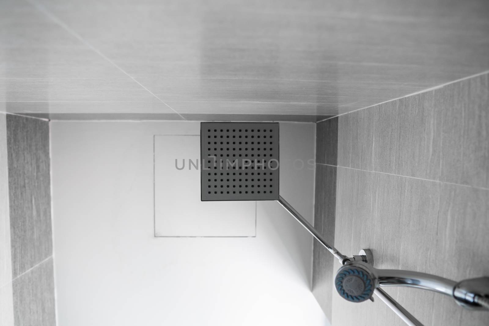 Square shower head and classic shower head in a modern bathroom. Shower in the bathroom with water spray or water. A stream of fresh water from the shower head to clean the dirty body