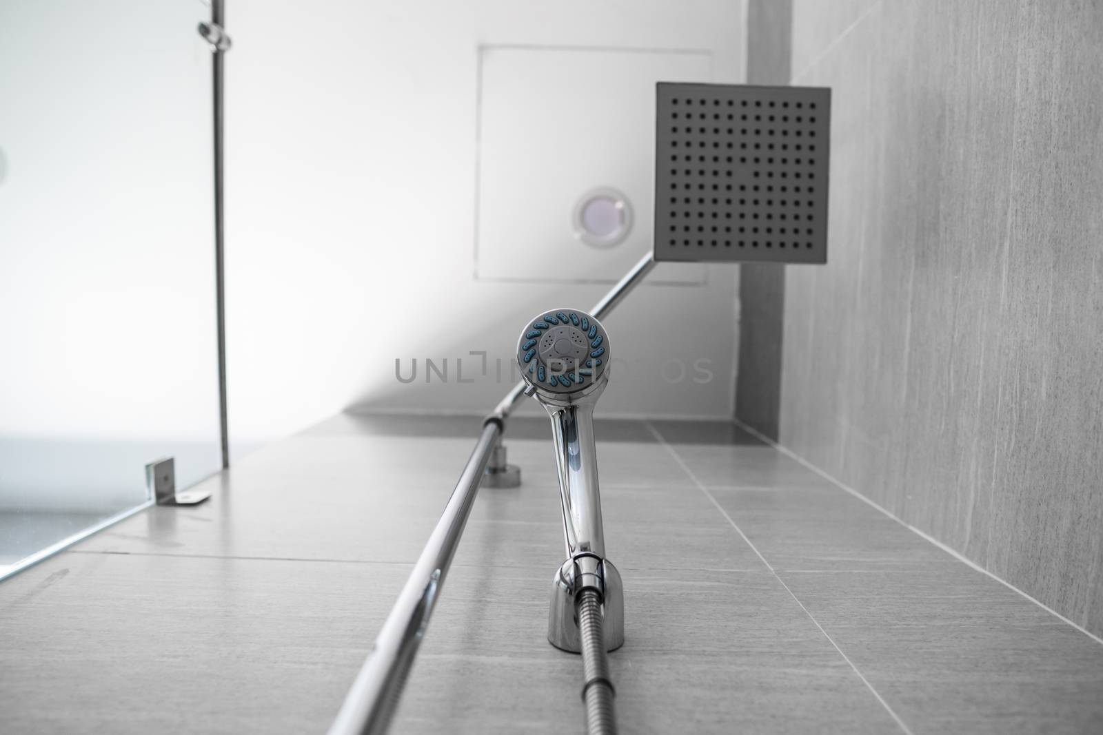 Square shower head and classic shower head in a modern bathroom. Shower in the bathroom with water spray or water. A stream of fresh water from the shower head to clean the dirty body