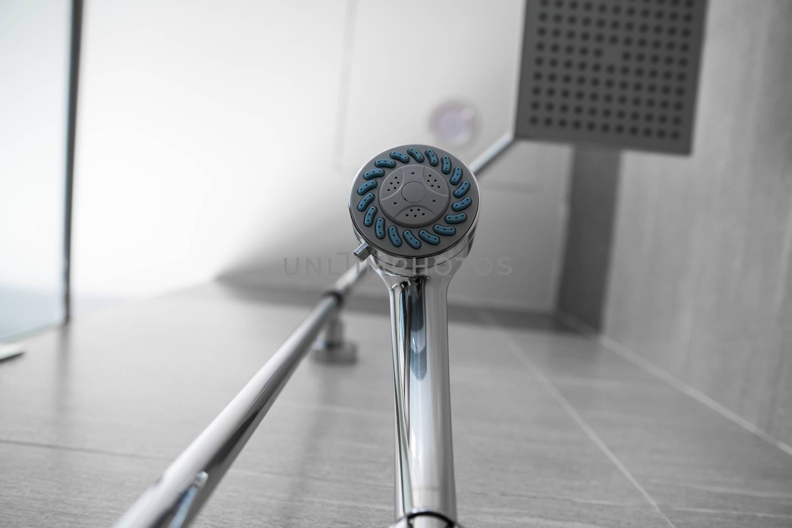 Square shower head and classic shower head in a modern bathroom. Shower in the bathroom with water spray or water. A stream of fresh water from the shower head to clean the dirty body