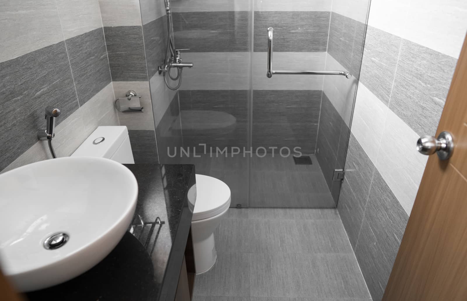 Shower cabin with a glass walls and door in a modern bathroom