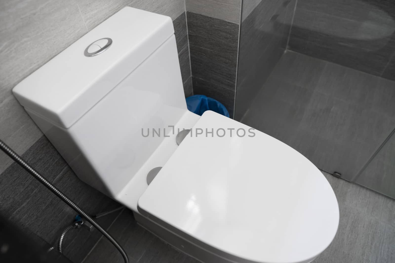 White toilet in modern home. White toilet bowl in bathroom