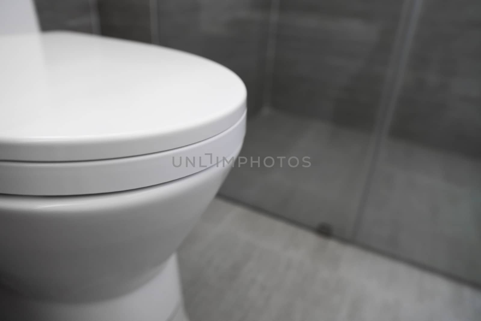 White toilet in modern home. White toilet bowl in bathroom. by vovsht