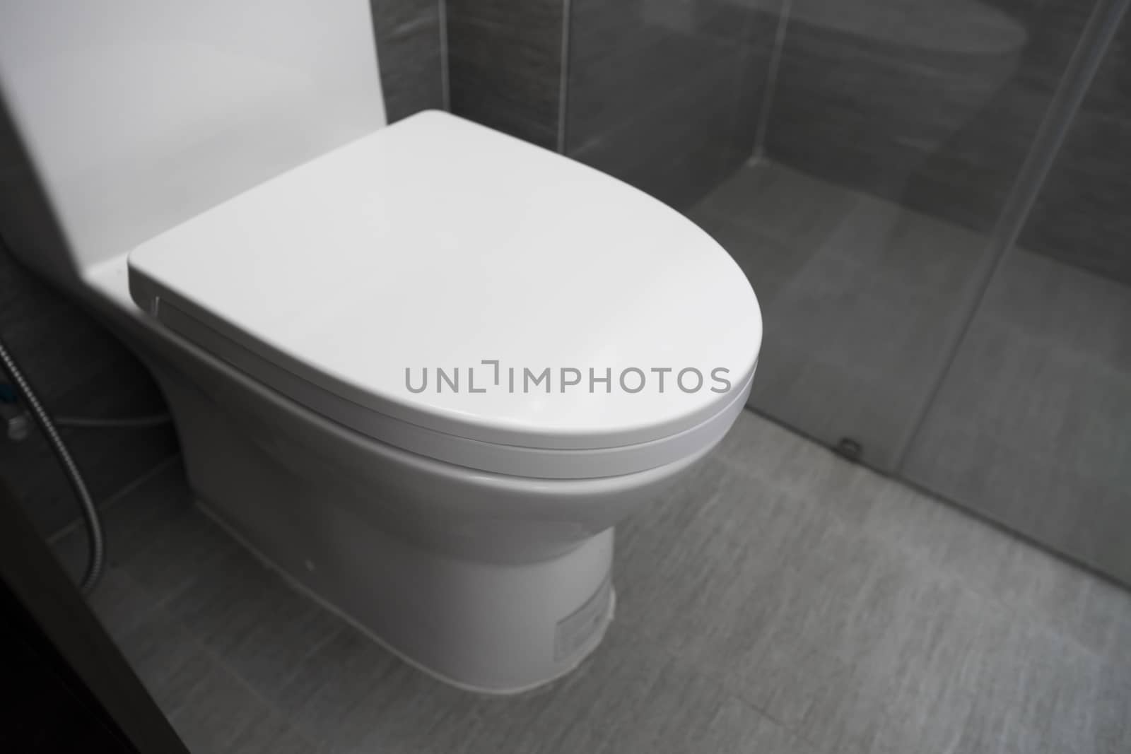 White toilet in modern home. White toilet bowl in bathroom