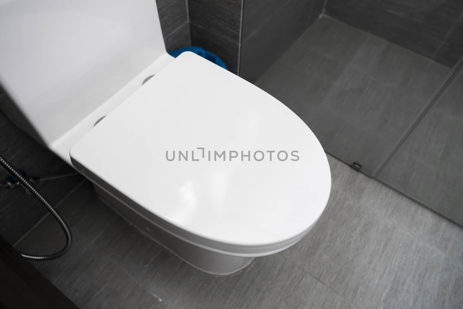 White toilet in modern home. White toilet bowl in bathroom. by vovsht