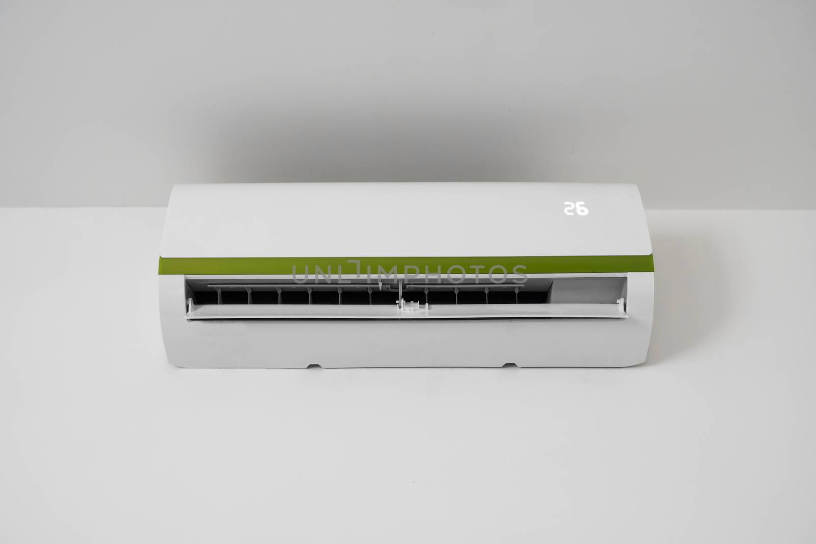 Air conditioner mounted on a white wall in the living room or bedroom. Indooor comfort temperature. Health concepts and energy savings