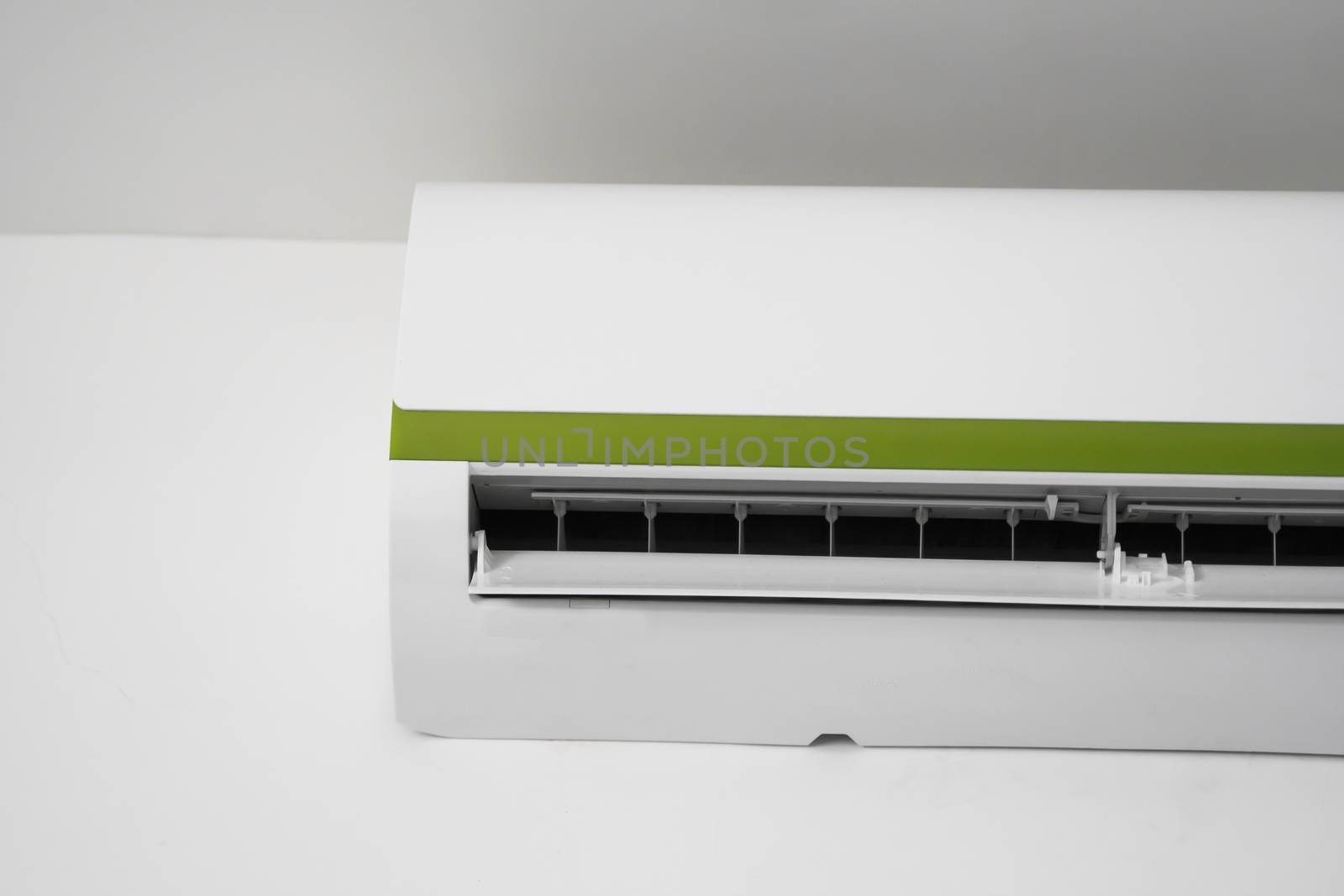 Air conditioner mounted on a white wall in the living room or bedroom. Indooor comfort temperature. Health concepts and energy savings. by vovsht