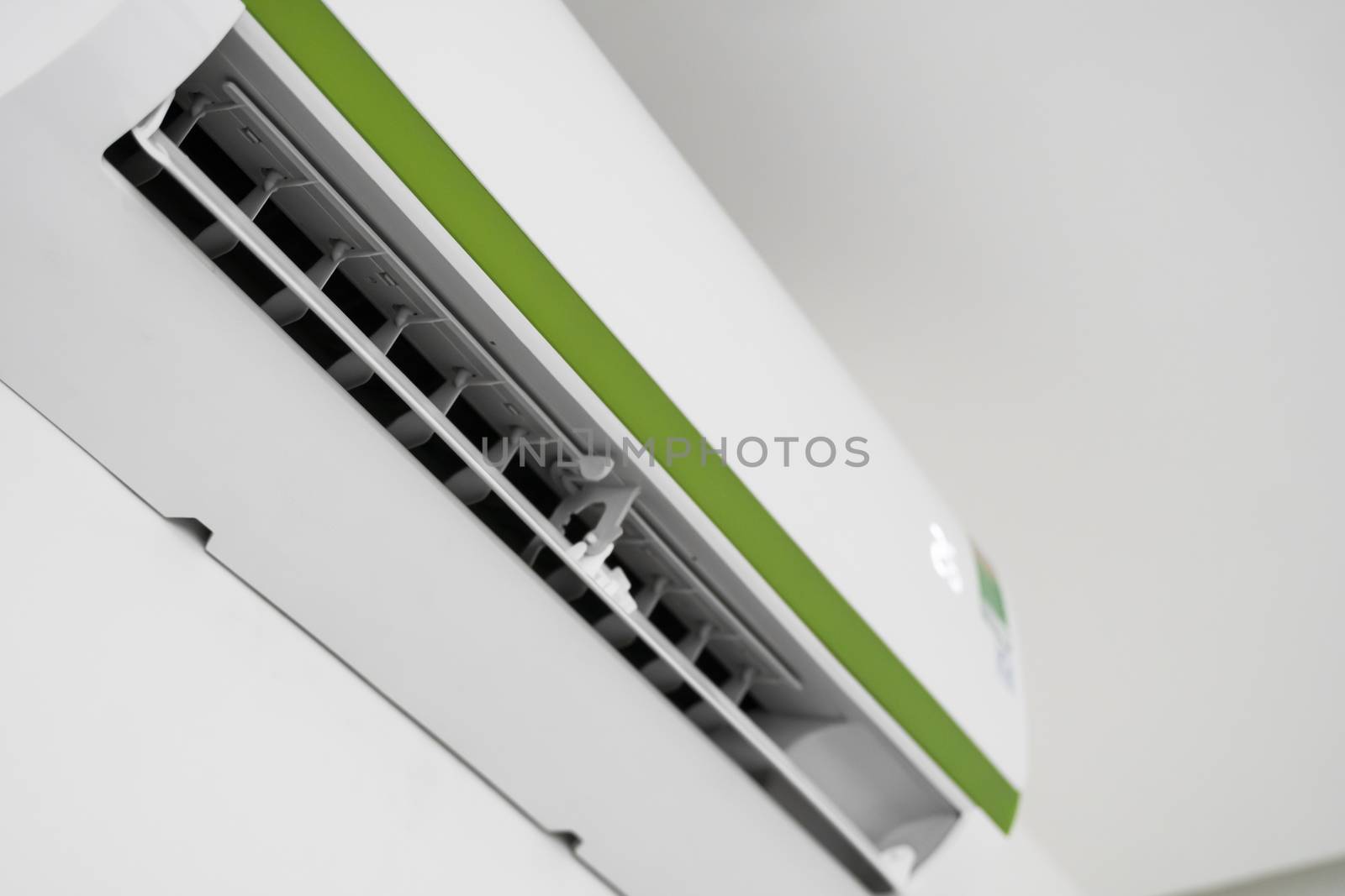 Air conditioner mounted on a white wall in the living room or bedroom. Indooor comfort temperature. Health concepts and energy savings. by vovsht